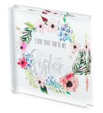 Load image into Gallery viewer, beautiful glass plaque that states &quot;I love that you&#39;re my sister&quot;.  Perfect inspiration for your sister.  Decor for home or office.  Can stand alone. Great for desk or shelf.  She&#39;ll love it.  Your sister will love it.
